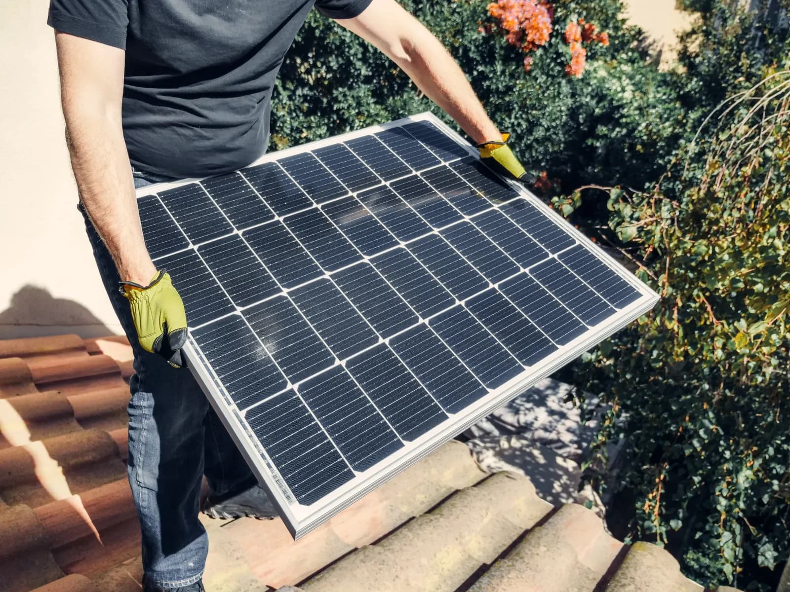 An installer carrying a solar panel